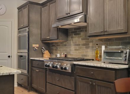 Two Gray Frying Pans Hanging on Wall